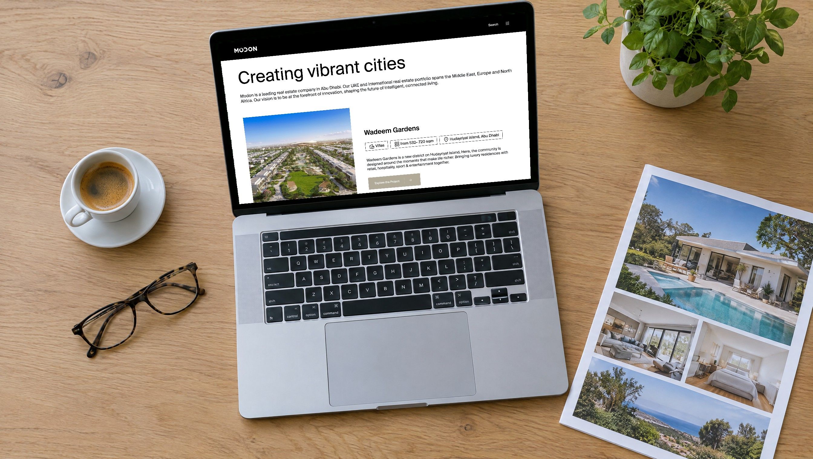 The modon.com real estate portfolio page on a laptop beside a property brochure