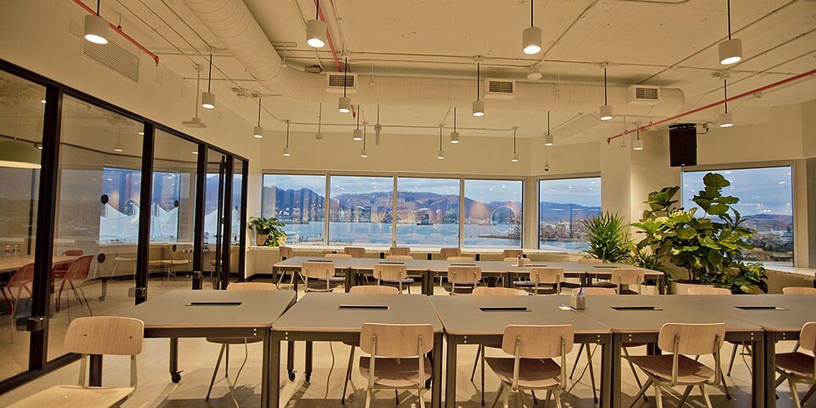 Bright open office with long desks and city views